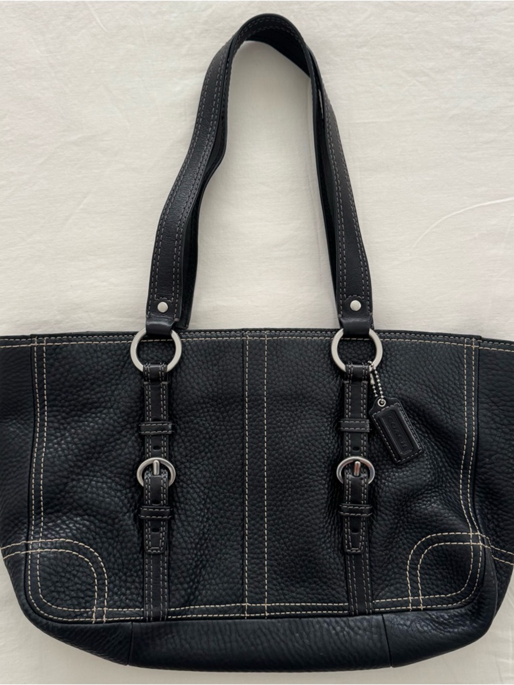 Black Coach leather buckle handbag with silver hardware